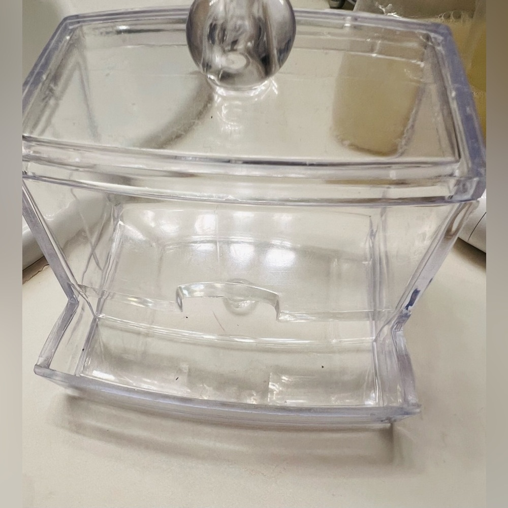 Clear cotton swab holder.